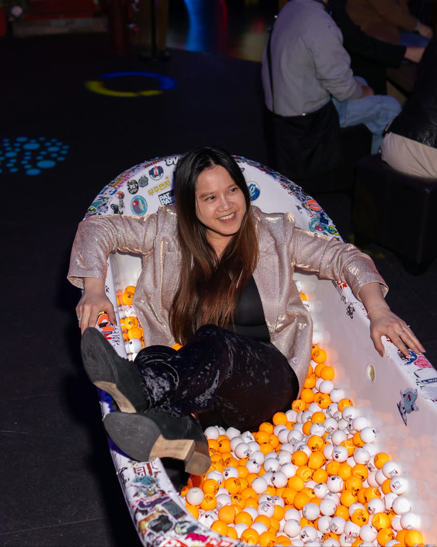 Guest playing in the colorful ball pit area at Space Ping Pong