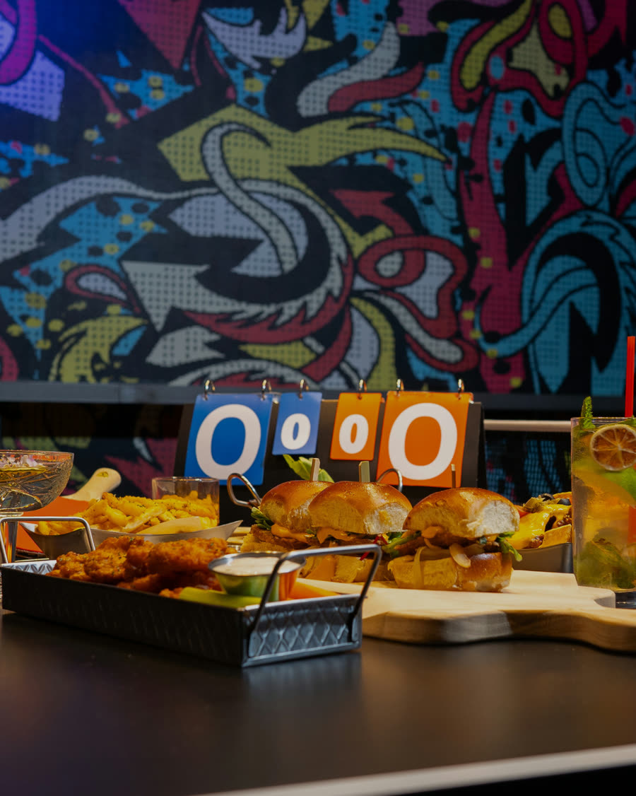Shareable food spread served at a Space Ping Pong table