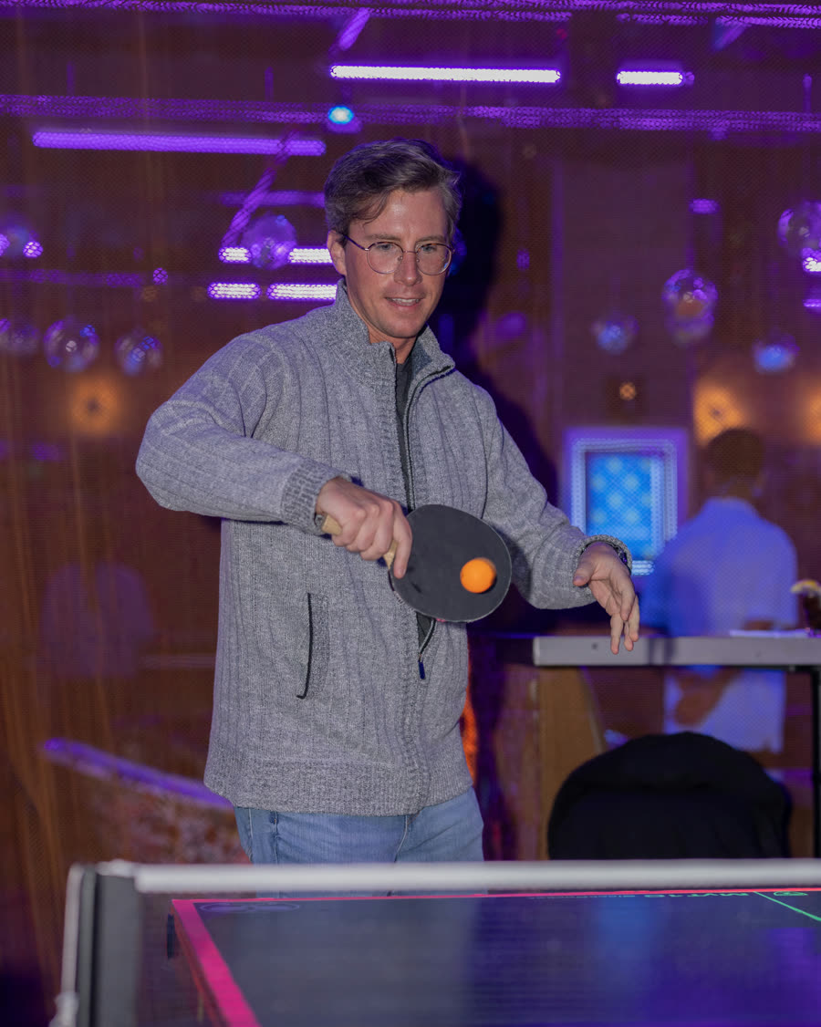 Guest playing ping pong at Space Ping Pong