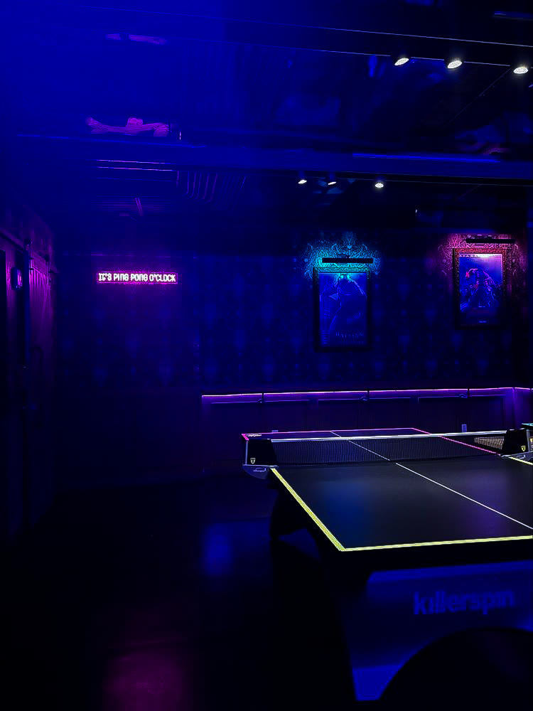 A Space Ping Pong table under neon lighting