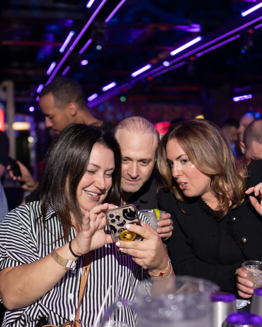 Guests holding drinks and socializing at Space Ping Pong